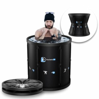 Man using a portable ice bath tub with lid nearby.